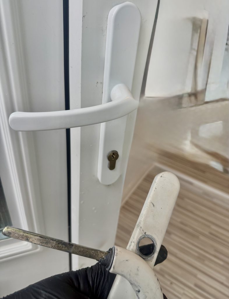 UPVC door handle replacement on residential property in Blyth, showing new white lever handle and euro cylinder alignment by Locksmith Kev